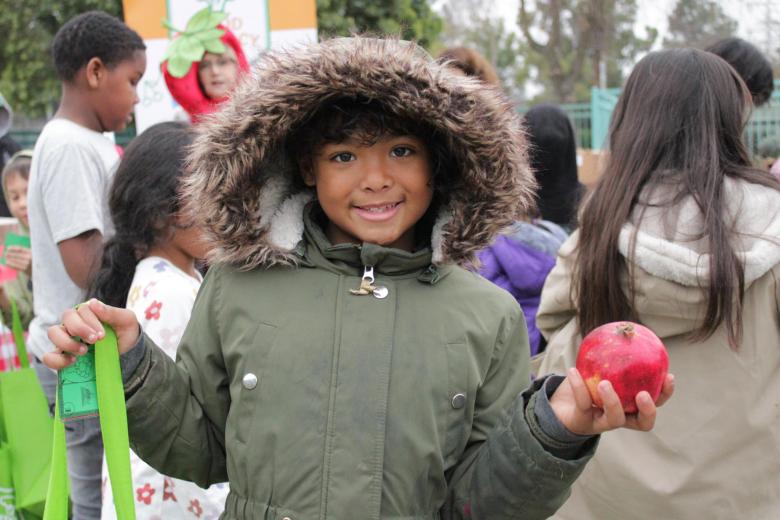 Students holding pomegranate